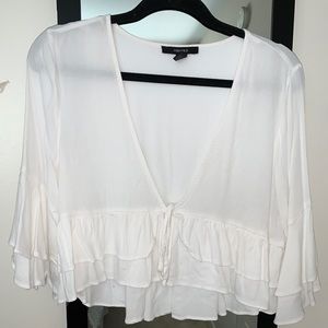 White ruffled top.